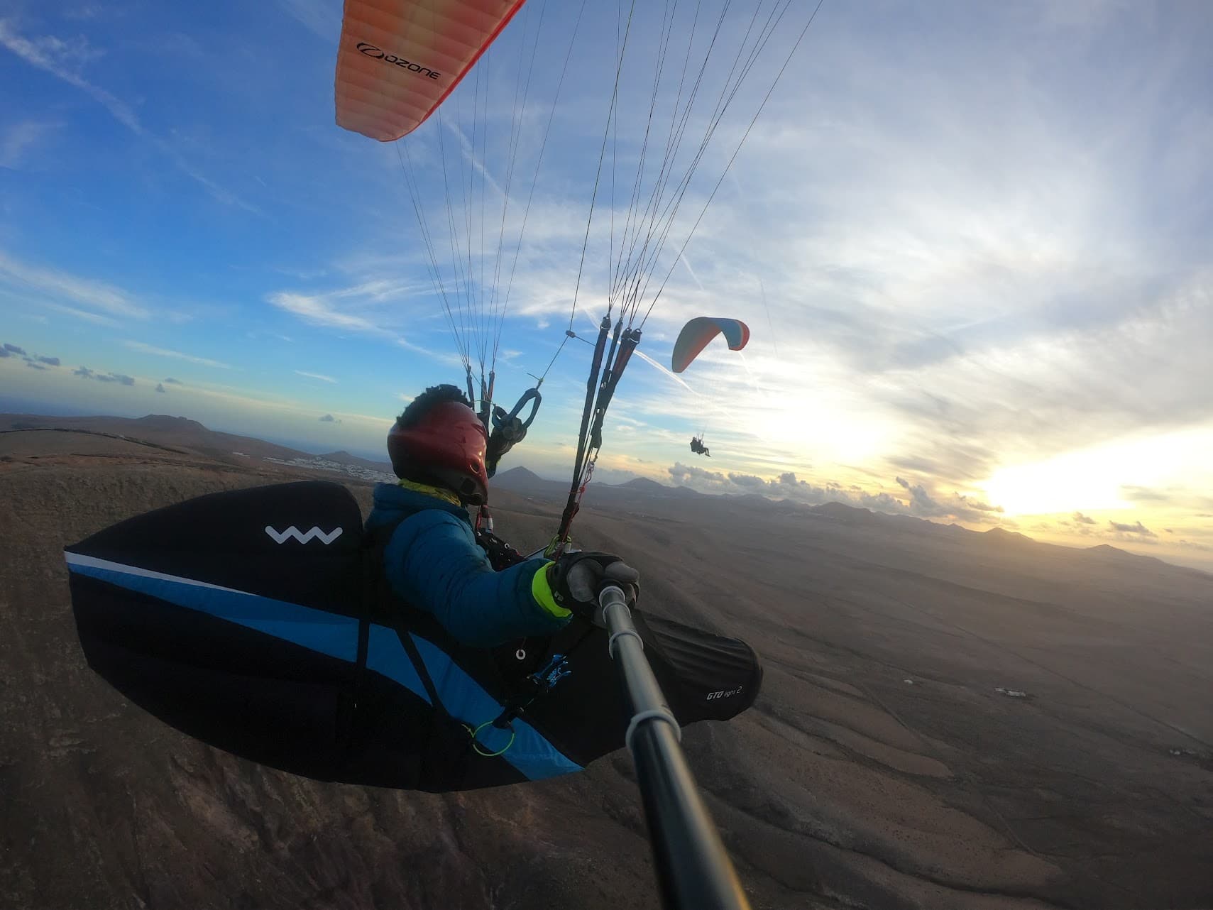 Paraglider soaring over Lanzarote's dramatic coastline